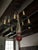 Colonial reproduction 8-arm chandelier in red, grey and black wood with metal arms. Beautiful and authentic reproduction...