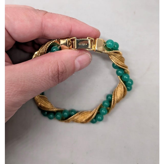 1960s goldtone textured with faux-jade beads wrapped bracelet fold over clasp. Marked "NAPIER" on the back of the clasp....