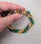 1960s goldtone textured with faux-jade beads wrapped bracelet fold over clasp. Marked "NAPIER" on the back of the clasp....