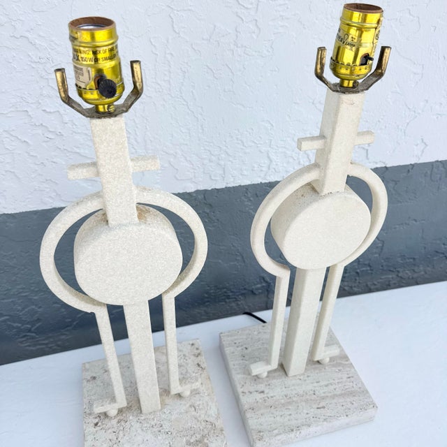 A striking pair of Mid-Century Modern sculptural table lamps showcasing bold geometric artistry and architectural...