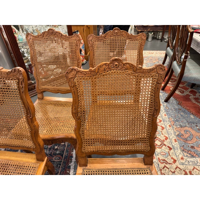 This is a set of four, 18th century antique French Louis XVI style cane dining chairs. They are walnut. They have fabulous...