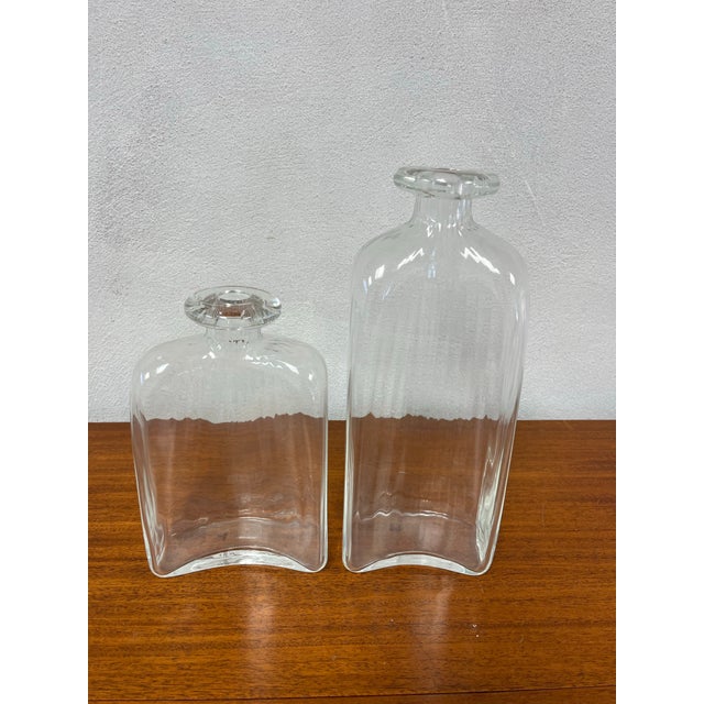 A sophisticated pair of Italian hand-blown art glass vessels produced for Vietri. Executed in substantial clear glass, the...