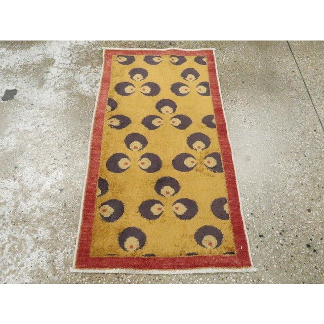 This Mid-20th century Turkish Art Deco throw rug, measuring 1' 9" x 3' 2", presents a bold and modernist design...