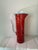 Colorful hand-blown glass pitcher with a red spatter/splatter pattern and turquoise rim, dating to approximately the...