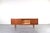 This teak sideboard was manufactured in Denmark in the 1960s. The piece of furniture has four drawers and a sliding,...