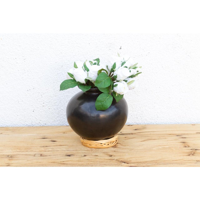 This 8-inch vessel is a larger expression of the storied Barro Negro tradition from San Bartolo Coyotepec, Oaxaca. These...