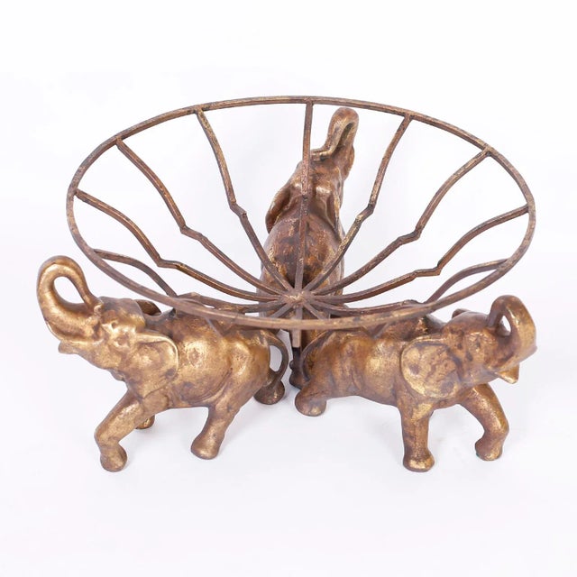 Anglo-Indian bowl with a gilt metal frame supported by three gilt metal elephants with their trunks up for good luck.