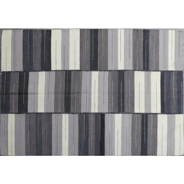 Beautiful new Kilim with geometrical tribal design and light colors, entirely handwoven with wool on cotton foundation....