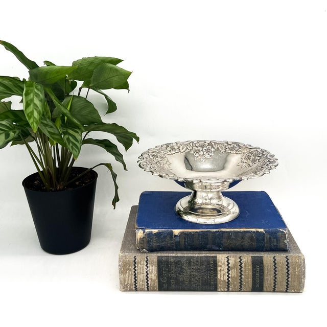 Elegant mid to late 20th century silverplate pedestal bowl featuring a beautifully detailed floral repoussé border with...