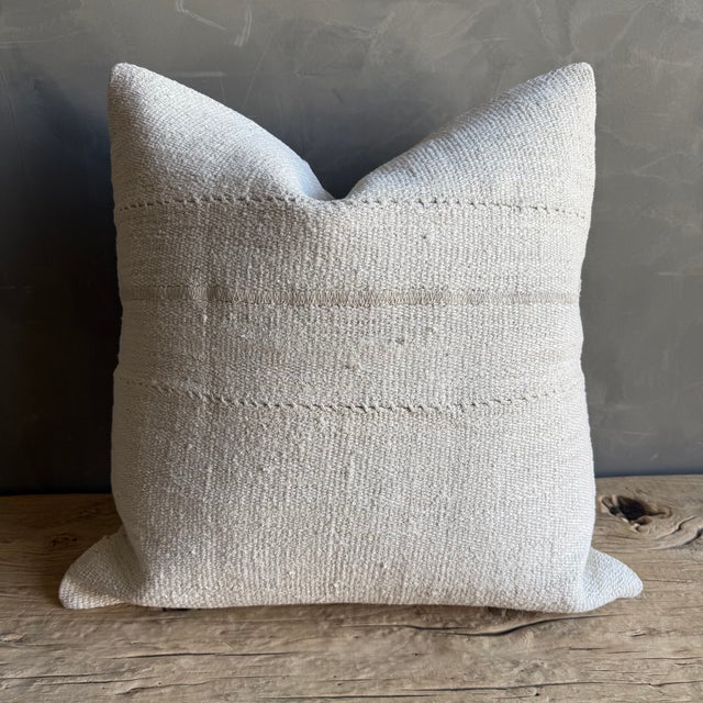 Creamy white hemp rug pillow with stripes. Soft hand, linen blend backing with zipper closure. Spot cleaning is...