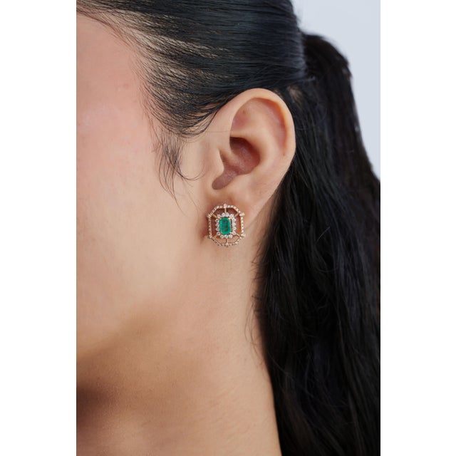 These elegant stud earrings feature 1.06 carats of emeralds, set in 14k yellow gold. Each measuring approximately 6 × 4 mm...
