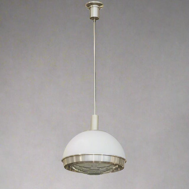 Pia Guidetti Crippa Modernist Pendant Light for Lumi. It features an illuminated faceted clear glass bottom with...