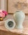 A monumental 1980s Haeger ceramic ginger jar in a glossy pale celadon glaze, complete with its original domed lid and...