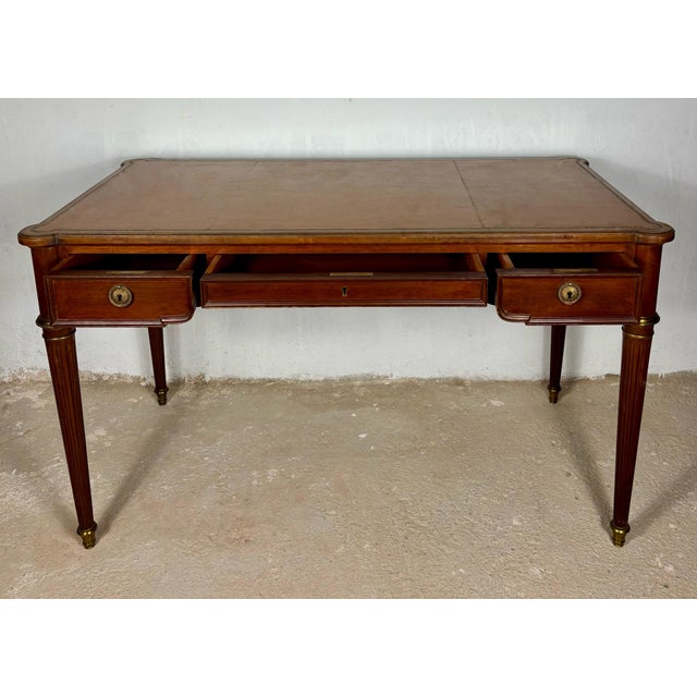 Elegant early 20th century writing desk crafted in hardwood and inspired by the refined lines of the Louis XVI period. The...
