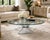 An exceptional sculptural lucite cocktail table featuring a dramatic radiating starburst base beneath a floating round...