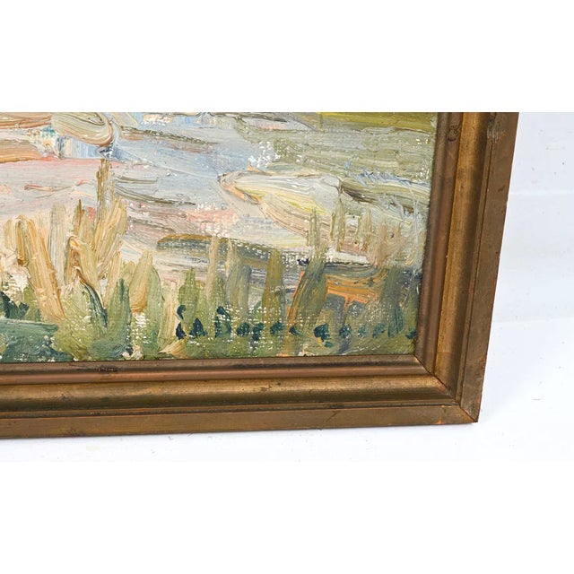 This signed oil on canvas depicts a tranquil marshland beneath an expansive, dramatically painted sky. Thick, expressive...