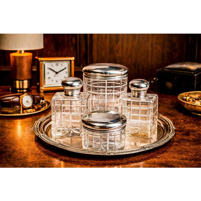 A distinguished collection of Mappin & Webb antique crystal and sterling silver vanity jars and bottles, notable for its...