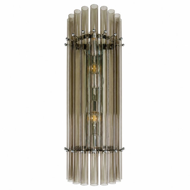 Elegant chromed wall sconce with smoked-fumè pipes of Glass. Fruit of hight italian craftmanship.Exclusive design by...