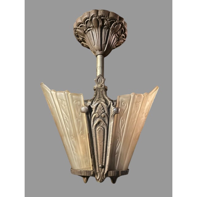 Beautiful matching pair of antique Art Deco two-light ceiling fixtures, circa 1920s–1930s, featuring ornate cast metal...