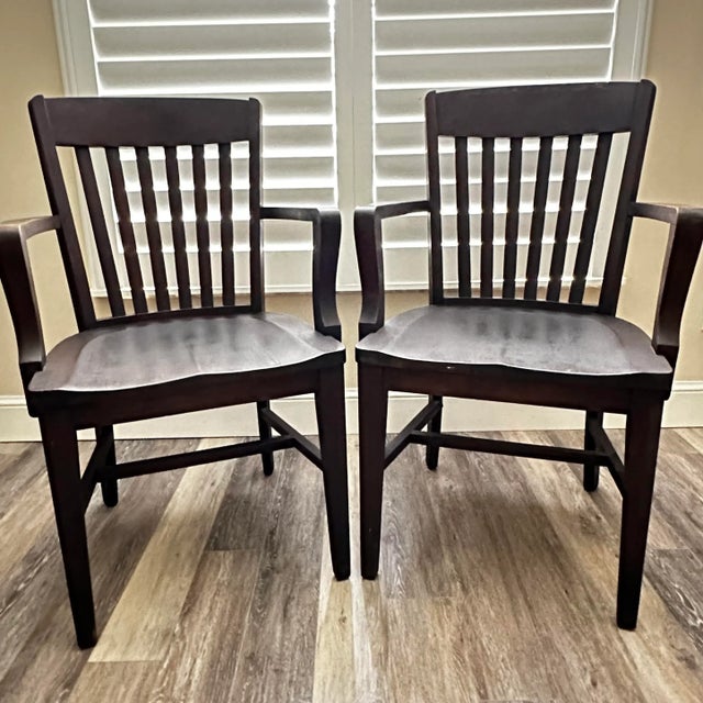 Monroe Benbrook & Co. Chicago set of 2 courthouse chairs. Solid wood with Saddle style seats and 6 back slats. Each chair...