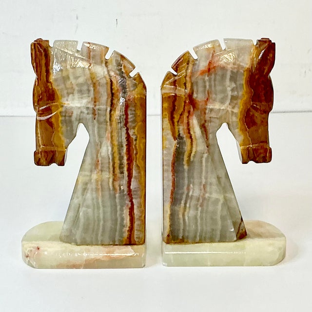 VINTAGE HOME is pleased to offer this set of Hand-Chiseled Italian Onyx Marble Horse Bookends. The grain is in neutral...