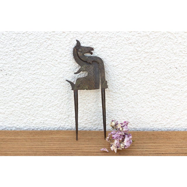 An exceptional Early 19th-century North Indian hand-cast bronze and iron betel nut cutter (Sarota), featuring a...