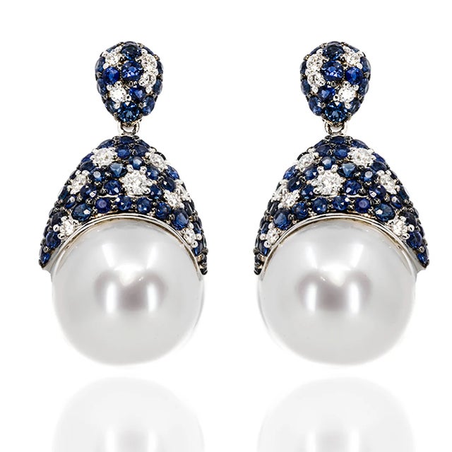 18k WHite gold earrings with 2 South Sea pearls measuring 13-14mm and 106 sapphires weighing 3.07 carats and 26 diamonds...