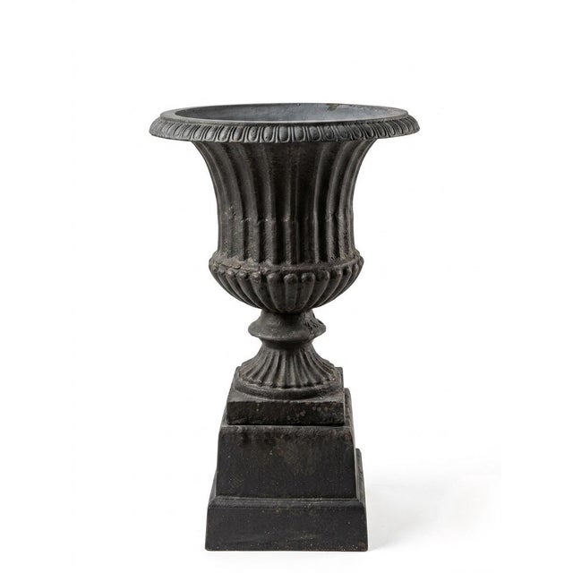 This striking garden urn embodies the timeless elegance of Neoclassical design, featuring a classic campana-style...