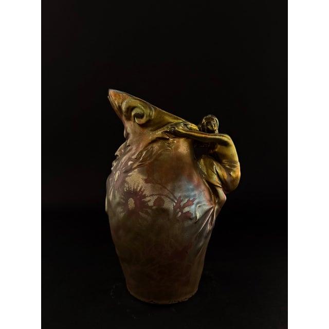 Ceramic jug with metallic luster glaze by Delphin Massier (1836-1907) from the late 19th century. The body of the jug...