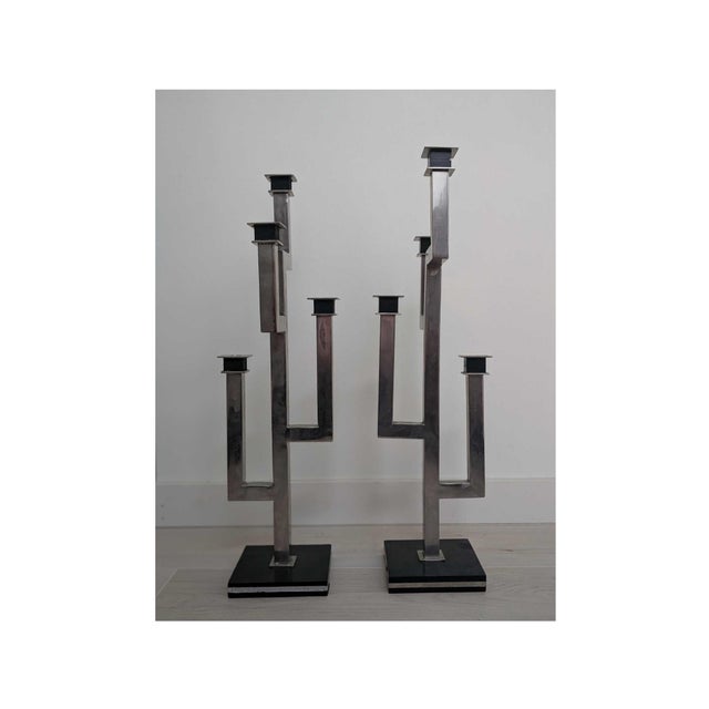 Chrome Pair Geometric Candelabras. Chrome with black wooden bases. One has gold trim around base, the other is missing it....