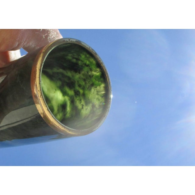 Fine home decor, a deep green nephrite vase with a thin modern edge in lacquered brass. Soft swelling walls that narrow to...