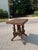 Antique Victorian barn house table made out of wood. The table features intricate carvings and wheels. The table is in...