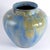 A striking ceramic vase decorated with a multi-hued dripstone glaze. A classic example of Art Deco design. Signed....