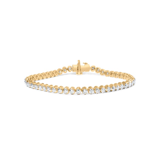Slip on a ribbon of daylight that bends to your every movement. This gleaming bracelet traces the wrist with a continuous...