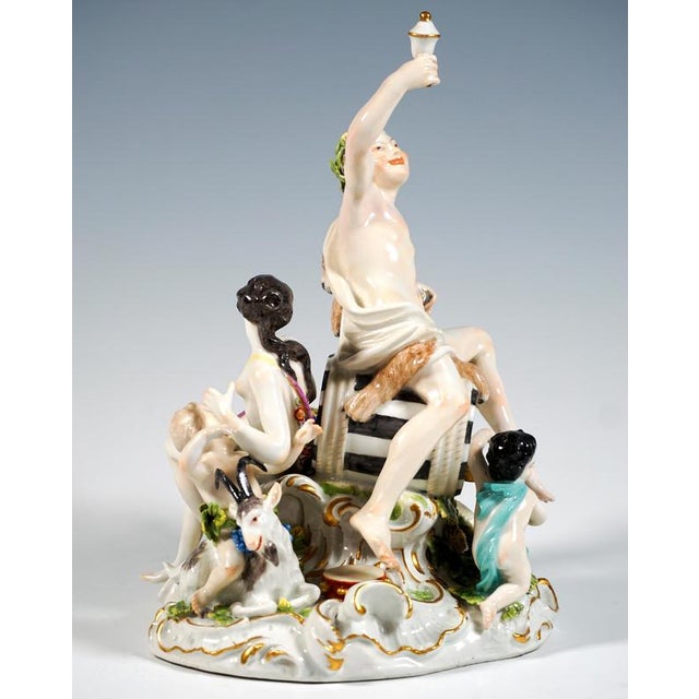 Rare, excellent porcelain group from the time of design: a youthful bacchus with a nymph and putti gathered around a large...