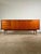 An elegant, Scandinavian-inspired teak sideboard dating back to the 1960s or 1970s, characterized by a refined, minimalist...