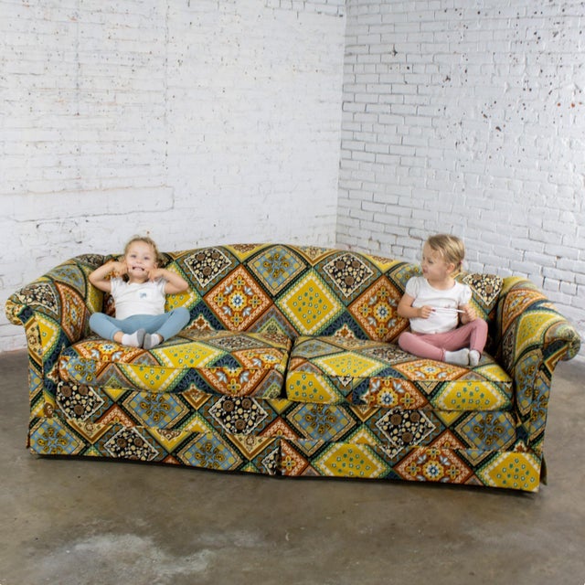 Handsome vintage camelback sofa with multicolored patchwork fabric and tight back by Rowe Furniture composed of rolled...