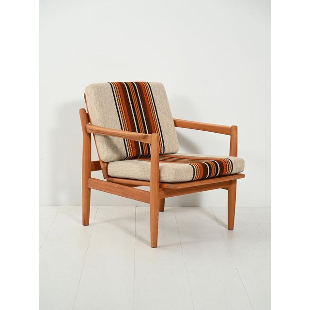 Norwegian pine armchair from the 1960s–70s, designed by Harry Moen for Bruksbo, with original wool upholstery. Designed by...