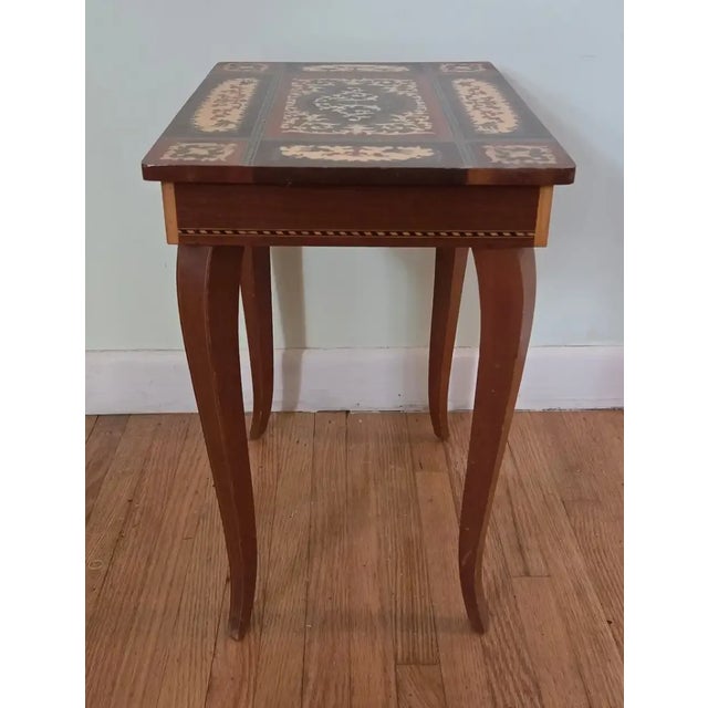 This stunning vintage Italian Sorrento-style marquetry inlay side table features a genuine Reuge Swiss musical movement...