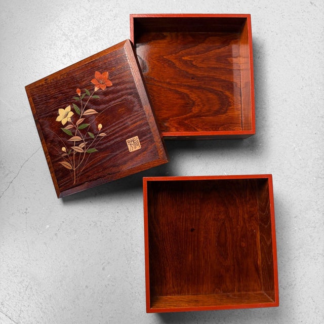 This two-tier Japanese jubako (stacking box with lid) is made from beautiful wood with a rich, flowing grain pattern....