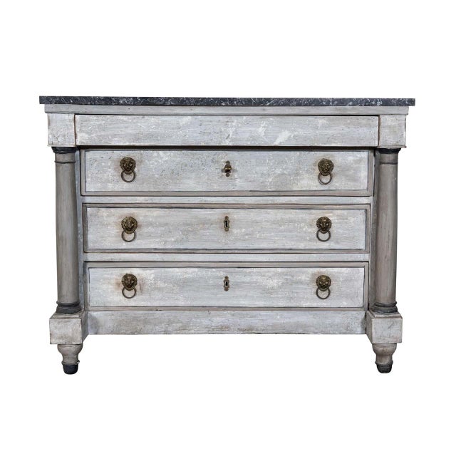 Empire commode with stone top. Four drawers with original lock and key hardware and lion head drawer pulls. Column front...