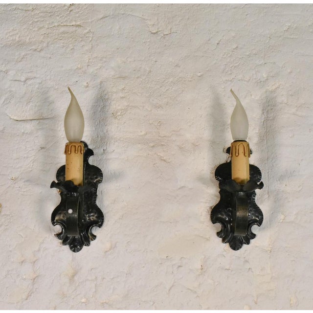 Pair of Mid Century Gothic Tole Wall Sconces A pair of matching Gothic Tole Wall Sconces mounted on a pressed metal...