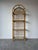 Beautiful vintage bamboo and rattan étagère featuring a graceful arched top and four open display tiers. This piece...