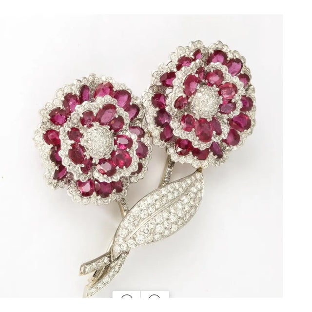 Hand-made 18kt white Gold Pin with two Flowers. Each set with 2 layers of Faceted Rubies and Diamond Petals with one Pave...