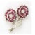 Hand-made 18kt white Gold Pin with two Flowers. Each set with 2 layers of Faceted Rubies and Diamond Petals with one Pave...