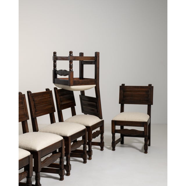 Conceived in France during the height of the Brutalist movement, this commanding set of six oak dining chairs embodies the...