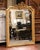 Crafted in France circa 1860, this elegant antique Louis XV wall mirror is distinguished by its richly carved giltwood...