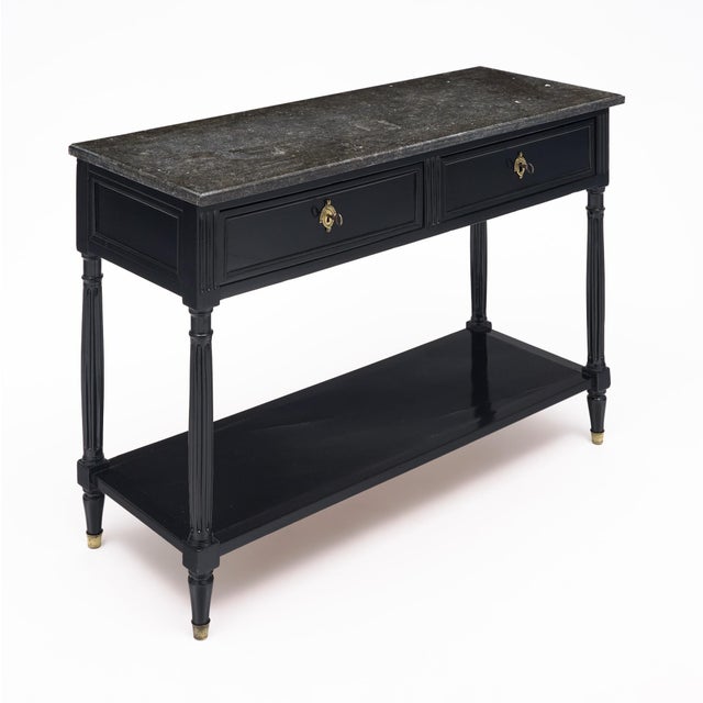 Console table from France from Louis XVI period. This piece is made of solid wood construction, primarily mahogany. It has...