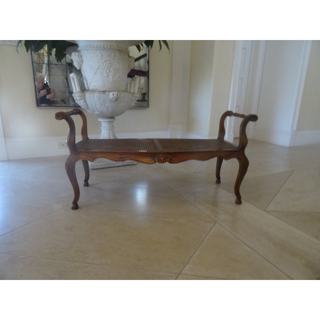 A well carved in walnut versatile bench with a newer cushion. Beautiful caining looks great with out a cushion