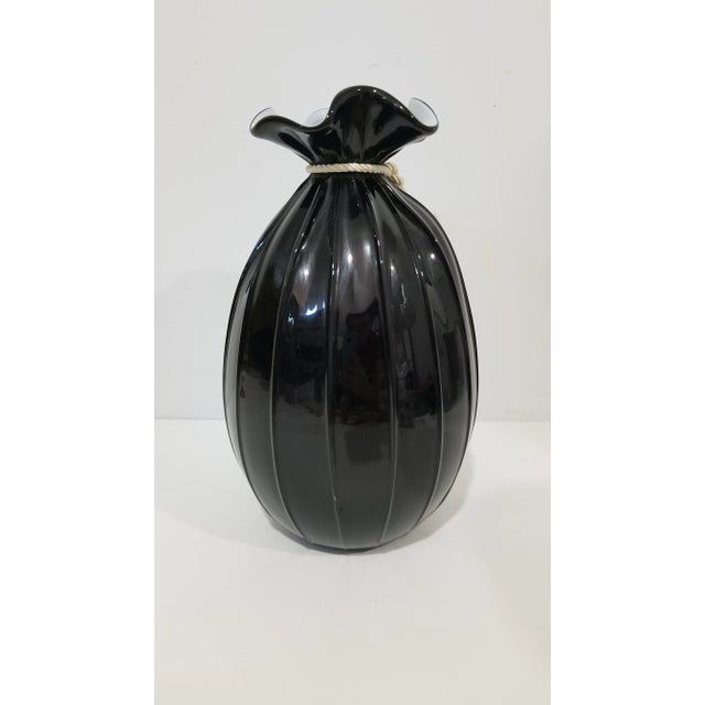 Large Art Glass Vase by Pilgrim Glass. This blown glass piece has "uneven folds" to resemble a fabric satchel, tied with a...